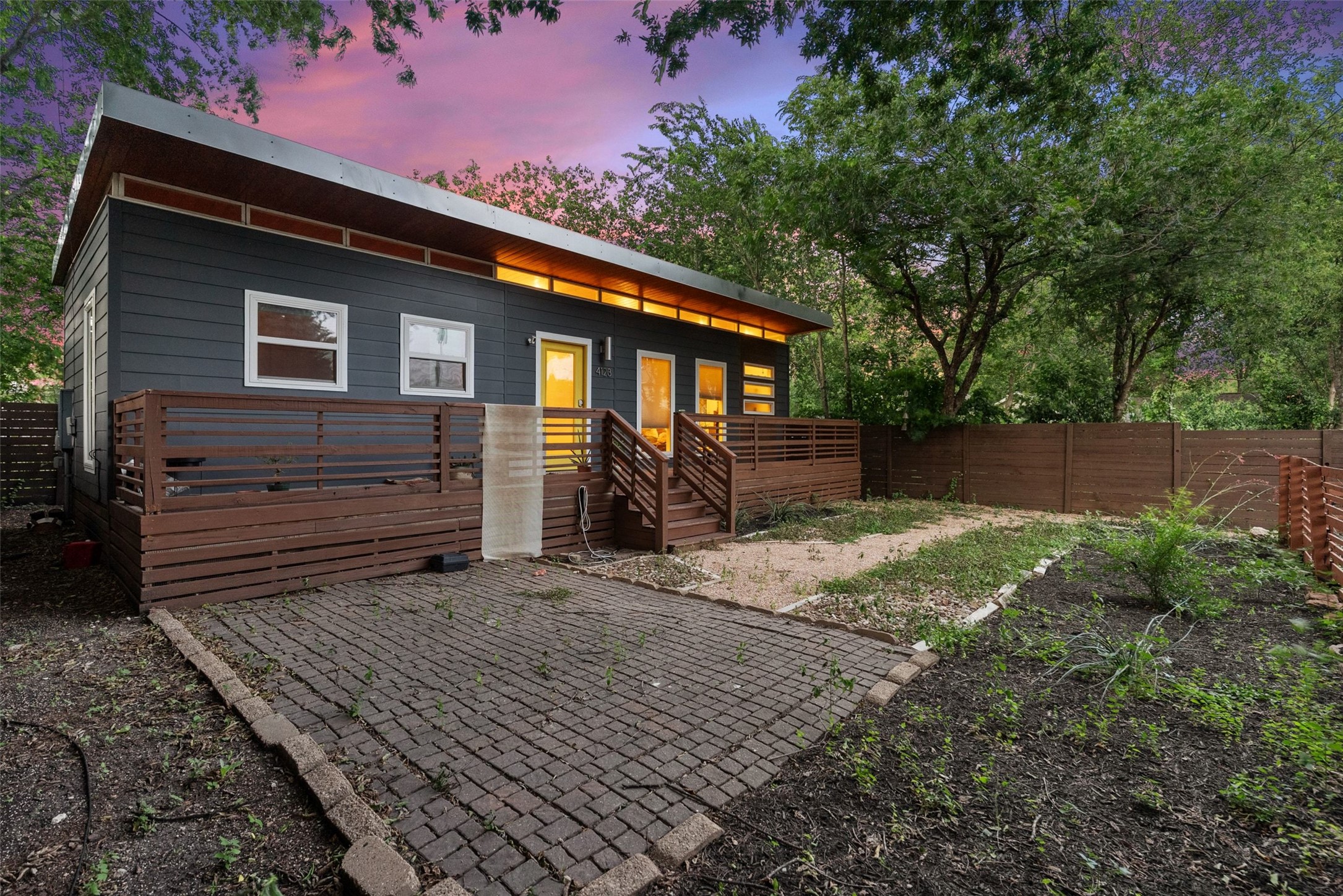 412 West Croslin Street Austin, TX 78752 - Photo 21 of 36 A modern facade with a striking roofline and a wooden deck for outdoor enjoyment.