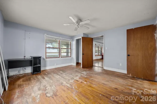 an empty room with windows and closet
