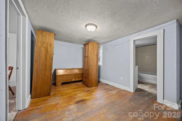 a spacious bathroom with a toilet a sink and a mirror