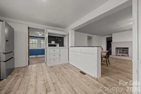 a view of a kitchen with furniture and wooden floor