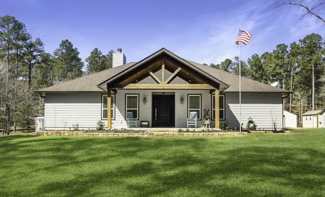 a front view of house with yard and green space