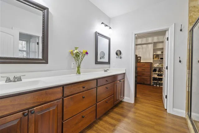 a spacious bathroom with double sink and a mirror
