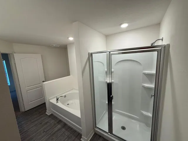 a bathroom with a bathtub and a shower