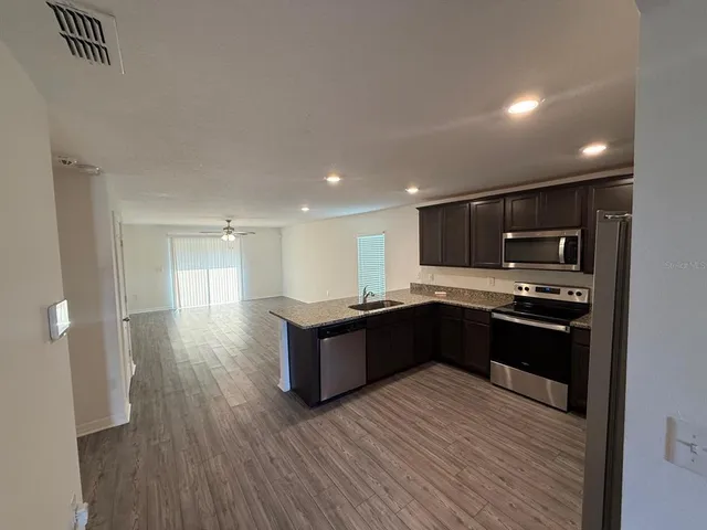 a kitchen with granite countertop a stove and cabinets