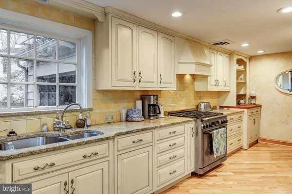 a view of a refrigerator in kitchen and an empty room