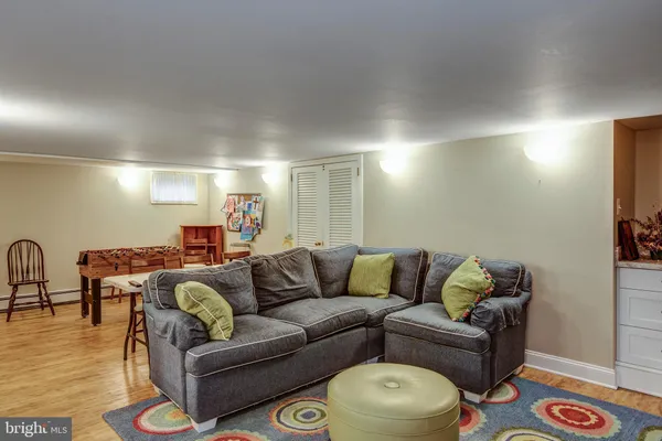 a living room with furniture and wooden floor
