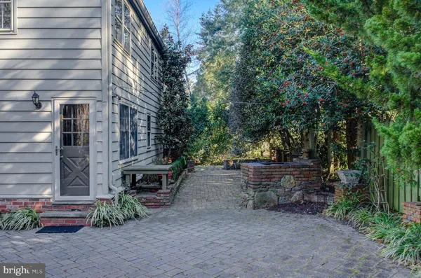 a view of a backyard with plants and a fire pit