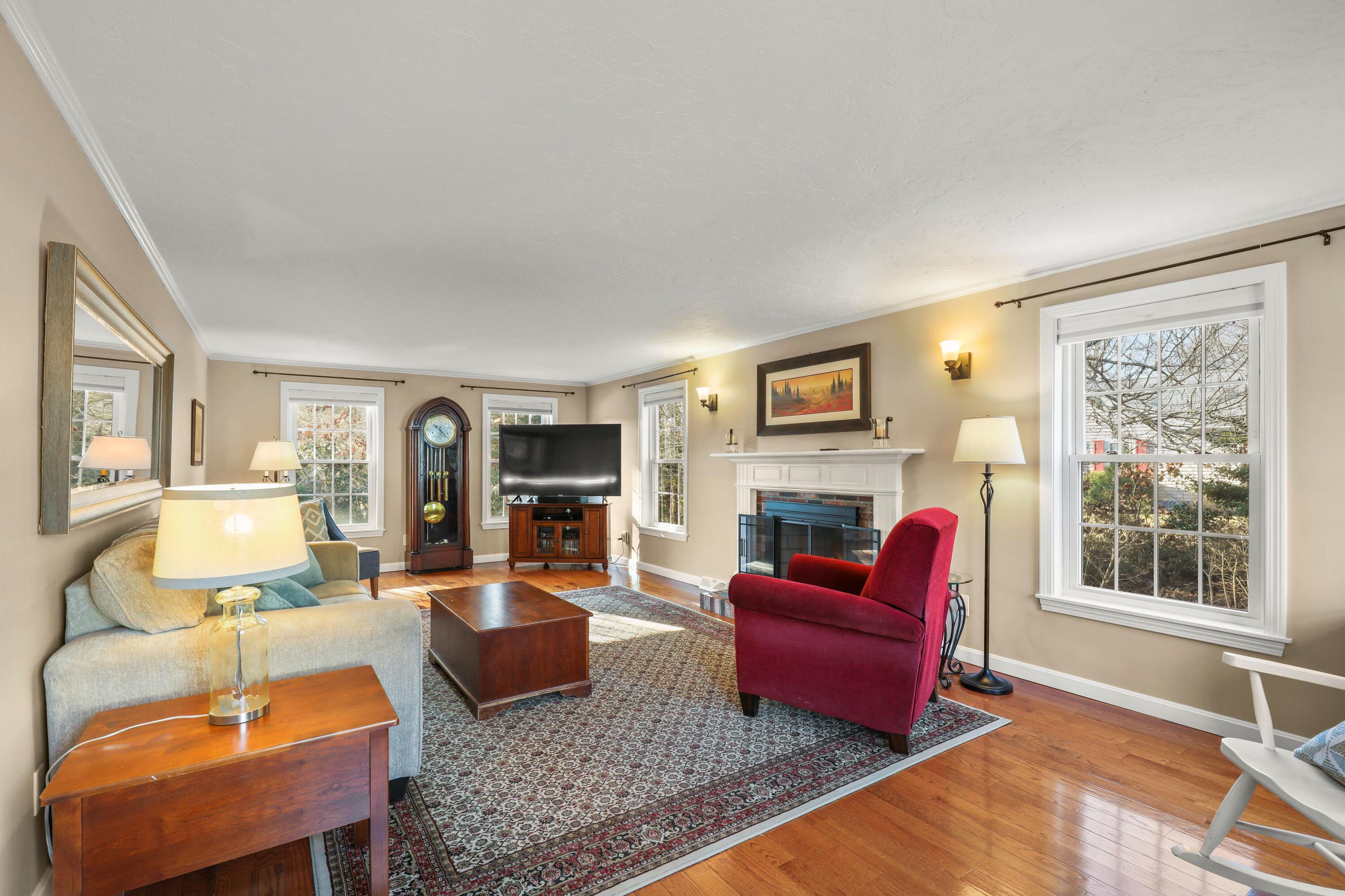 5 Vesper Drive Pocasset, MA 02559 - Photo 11 of 20 a living room with furniture a large window and a fireplace