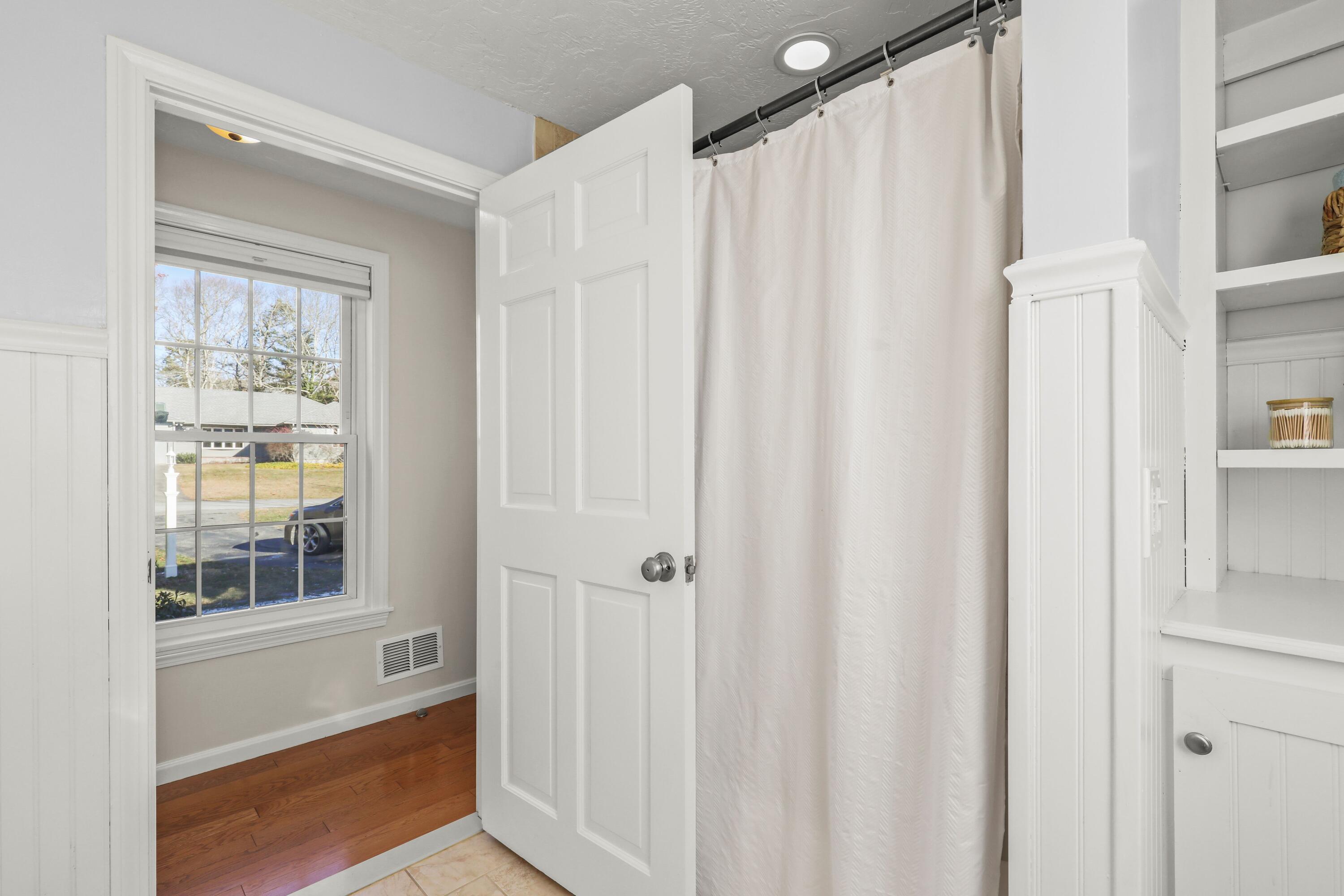5 Vesper Drive Pocasset, MA 02559 - Photo 14 of 20 a view of a bathroom with a window and a shower