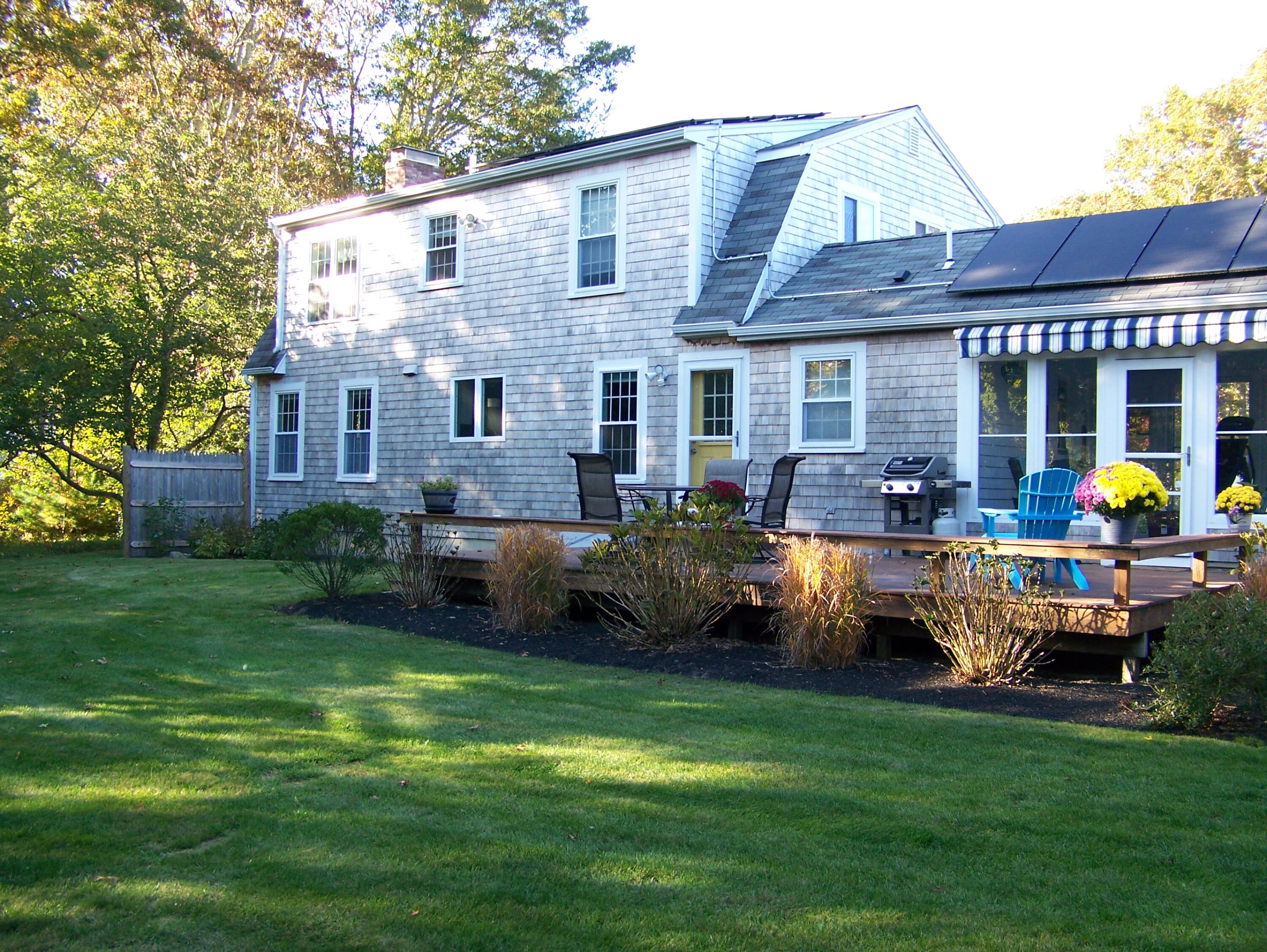 5 Vesper Drive Pocasset, MA 02559 - Photo 2 of 20 a front view of a house with garden and outdoor seating