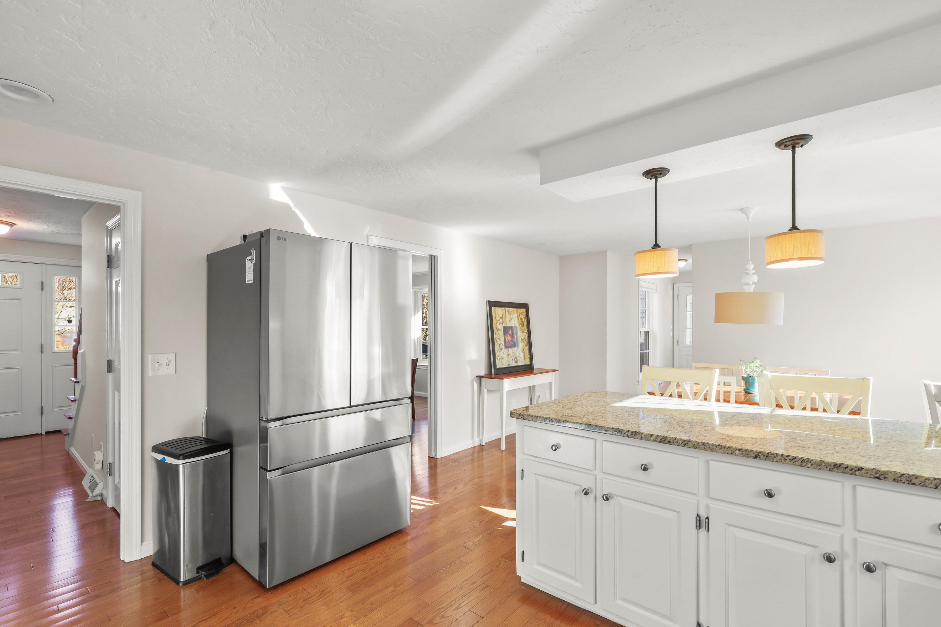 5 Vesper Drive Pocasset, MA 02559 - Photo 9 of 20 a kitchen with granite countertop a refrigerator and wooden floor