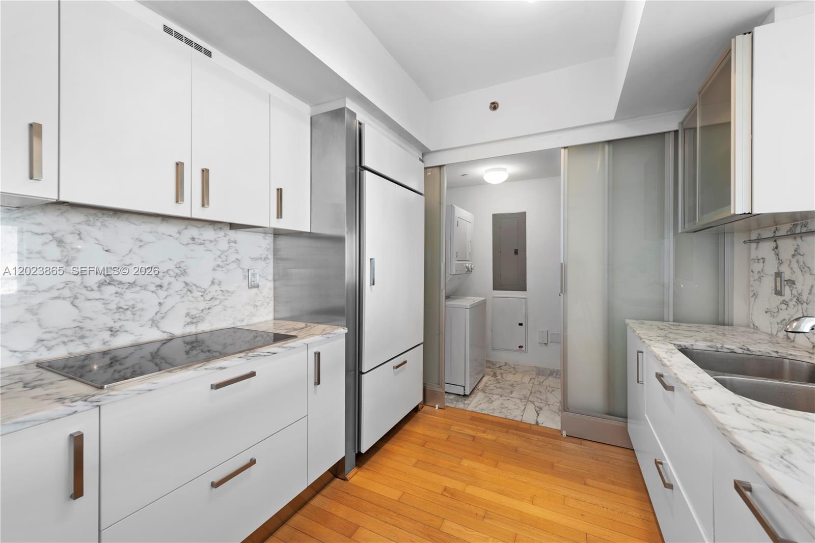 450 Alton Road, Unit 3206 Miami Beach, FL 33139 - Photo 9 of 25 a spacious bathroom with a granite countertop sink mirror vanity and bathtub