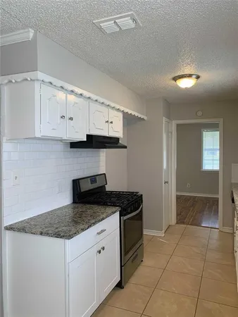 a kitchen with stainless steel appliances granite countertop a sink and cabinets