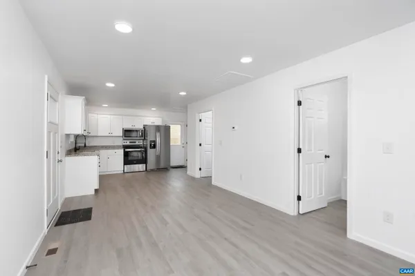 a view of kitchen with stainless steel appliances refrigerator oven and stove