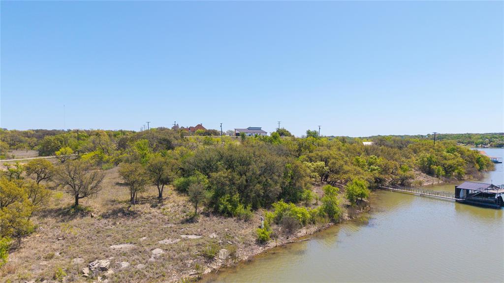Lot 23 Turner Ranch Road Brownwood, TX 76801 - Photo 4 of 13 Waterfront property featuring a private boat dock, lush green trees, and natural landscaping