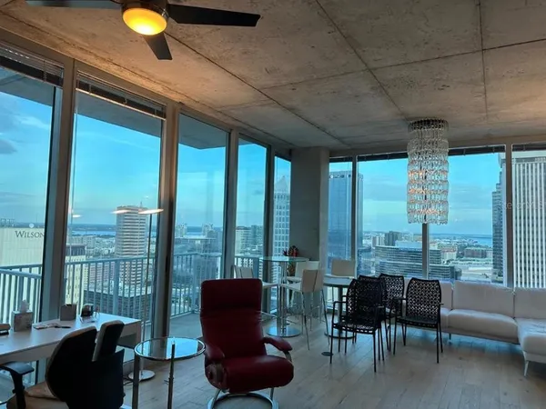 a bedroom with a bed chandelier and a window