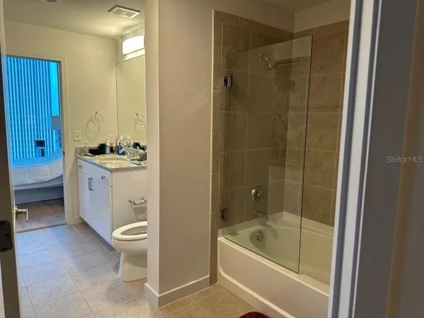 a bedroom with a bed and large window