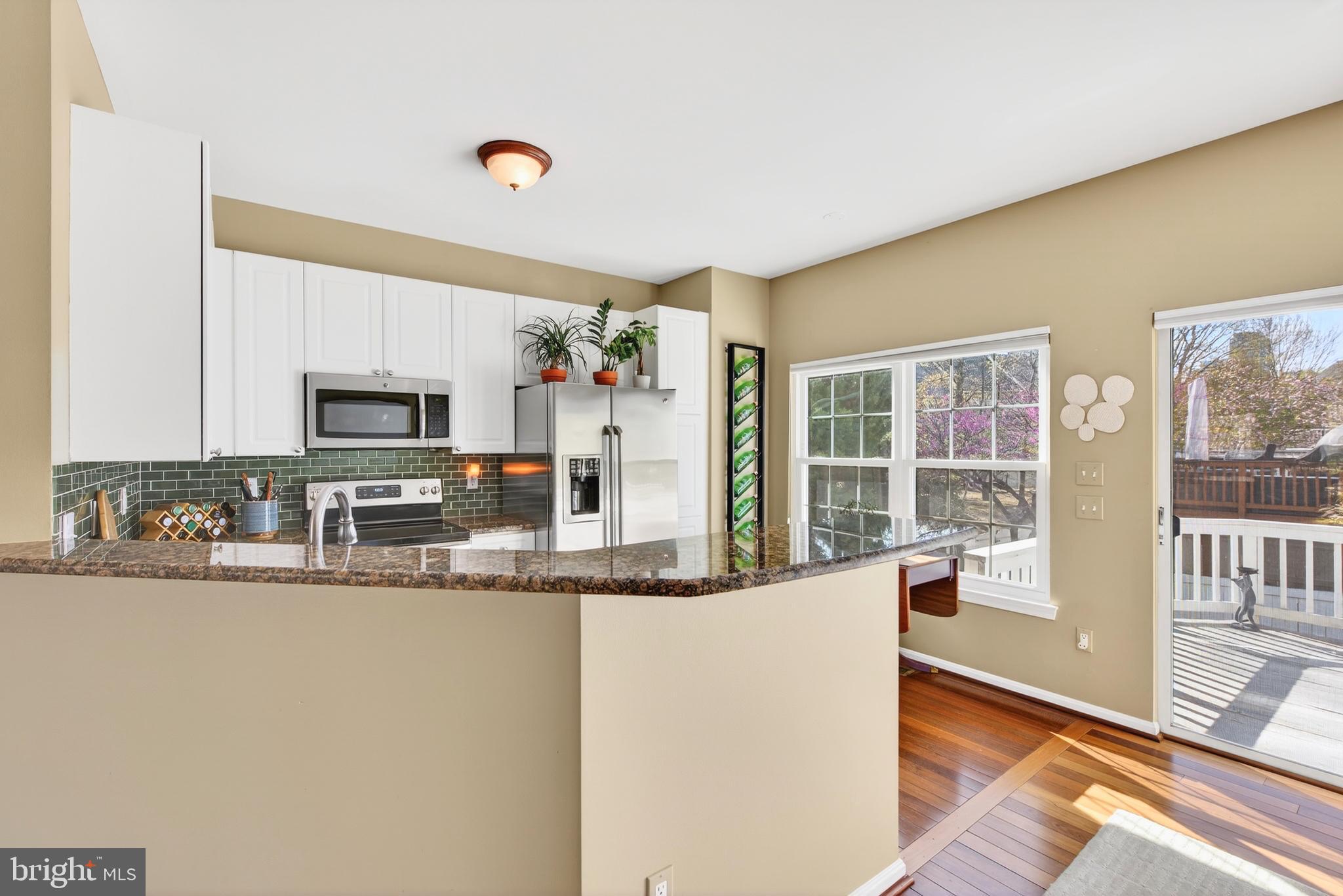 12017 Edgemere Circle Reston, VA 20190 - Photo 12 of 30 a kitchen with stainless steel appliances granite countertop a refrigerator a stove top oven and a sink with granite countertops