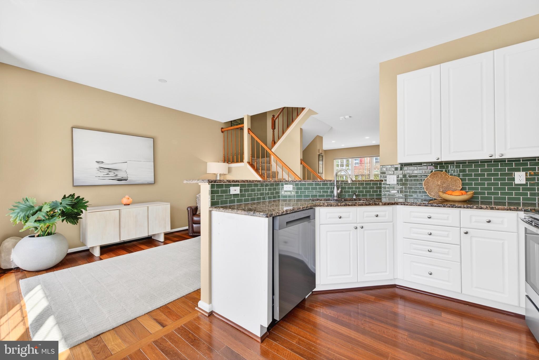 12017 Edgemere Circle Reston, VA 20190 - Photo 15 of 30 a living room with stainless steel appliances kitchen island granite countertop furniture and a wooden floor