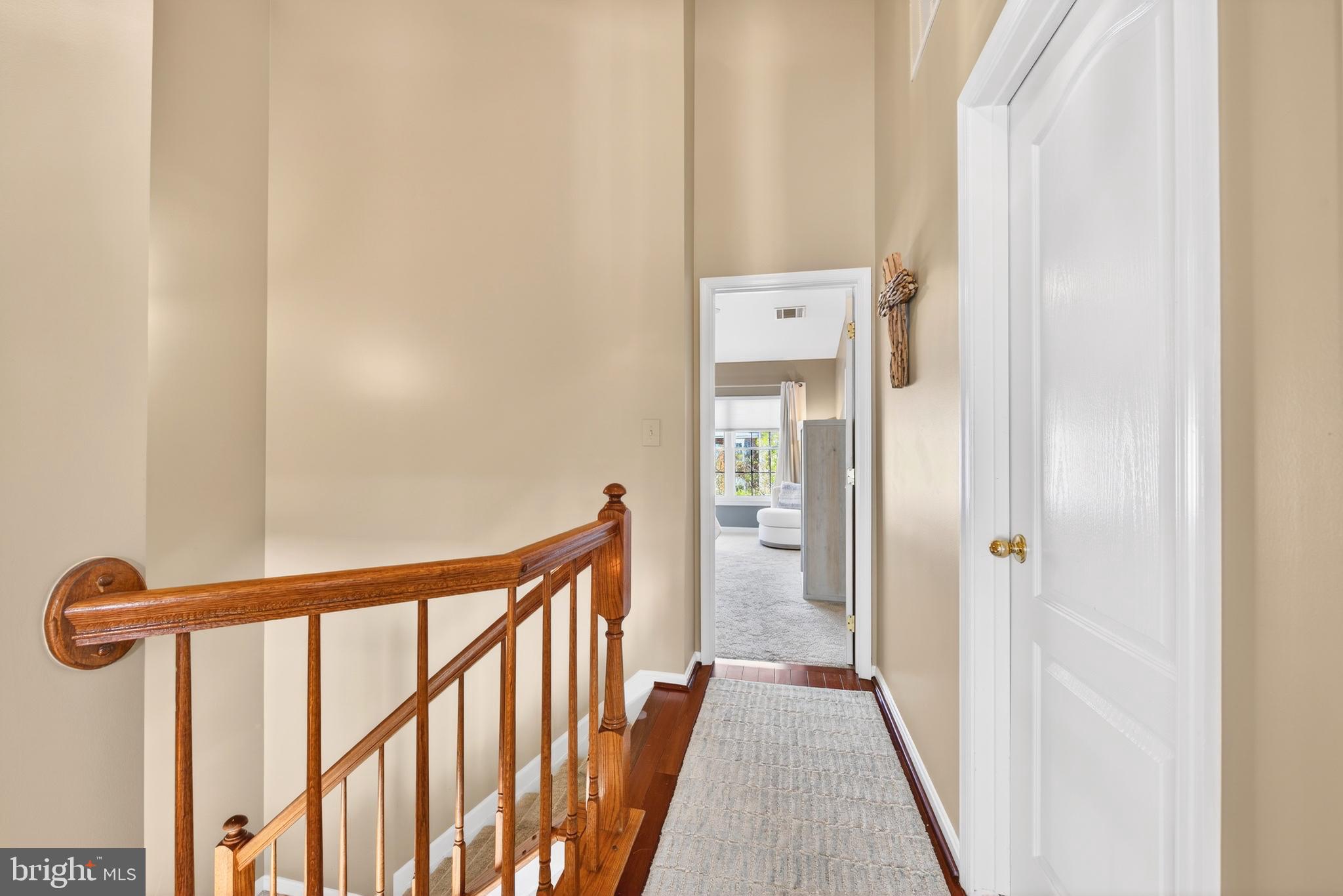 12017 Edgemere Circle Reston, VA 20190 - Photo 22 of 30 a view of a hallway with wooden floor and a bathroom