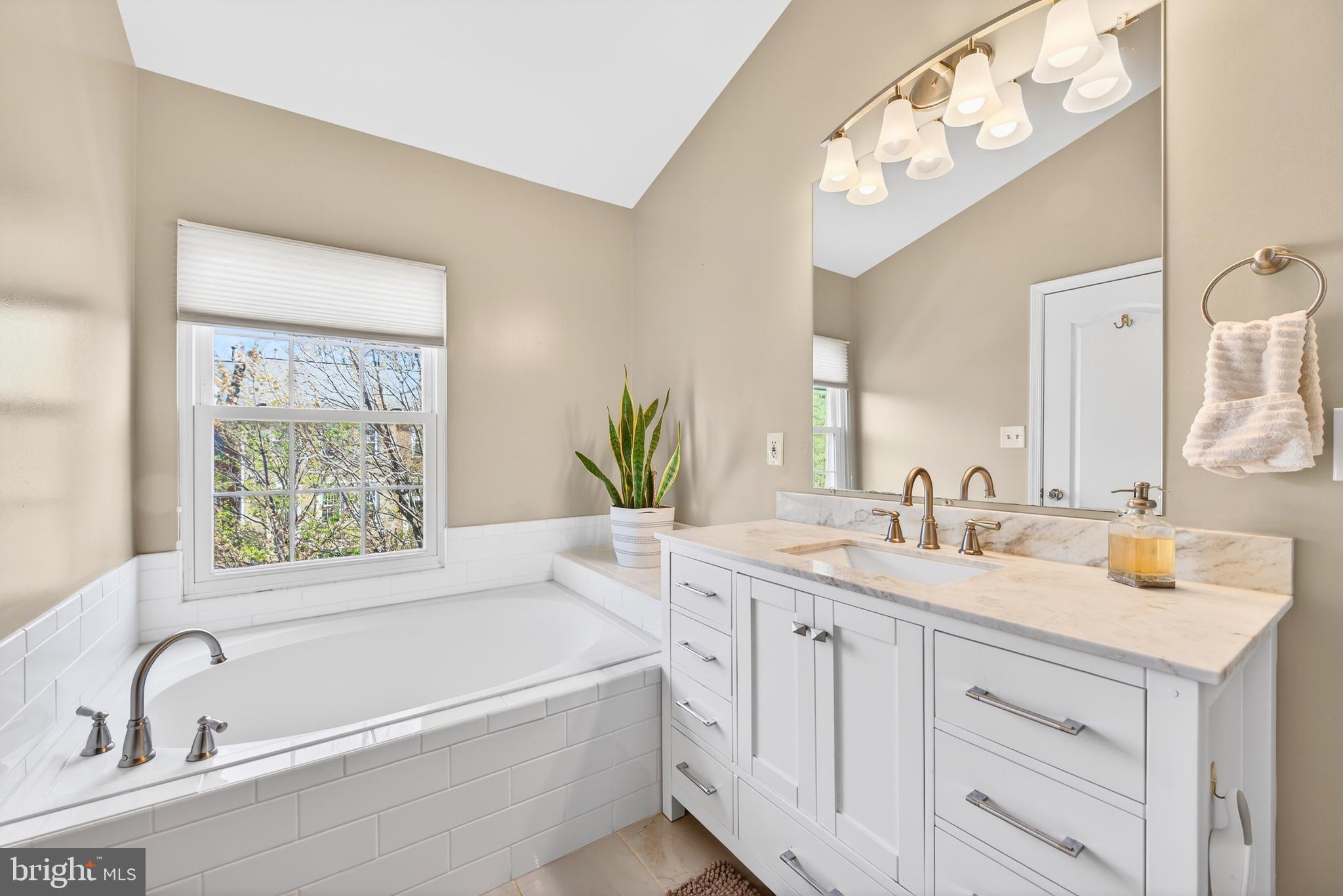 12017 Edgemere Circle Reston, VA 20190 - Photo 26 of 30 a bathroom with a tub a sink and mirror