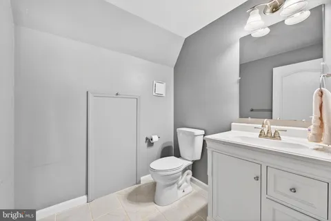 a bathroom with a toilet a sink and a mirror
