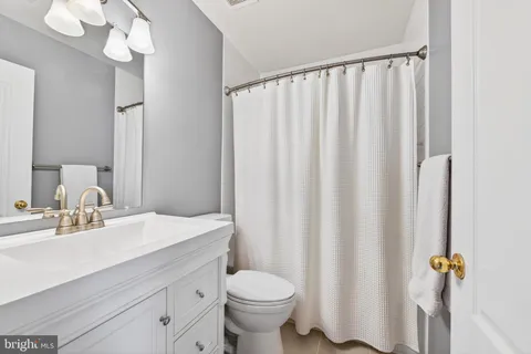 a bathroom with a sink a toilet and mirror