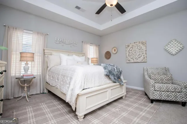 a bed room with a bed and a chair