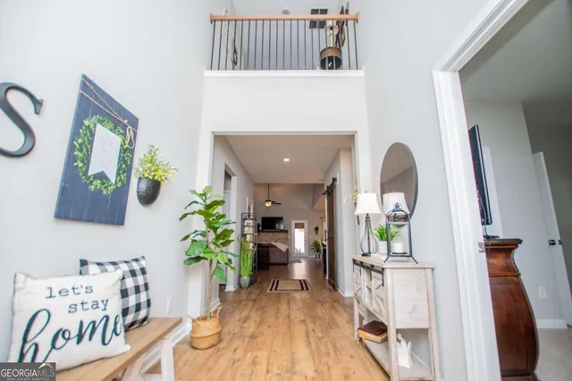 a living room with furniture and a chandelier
