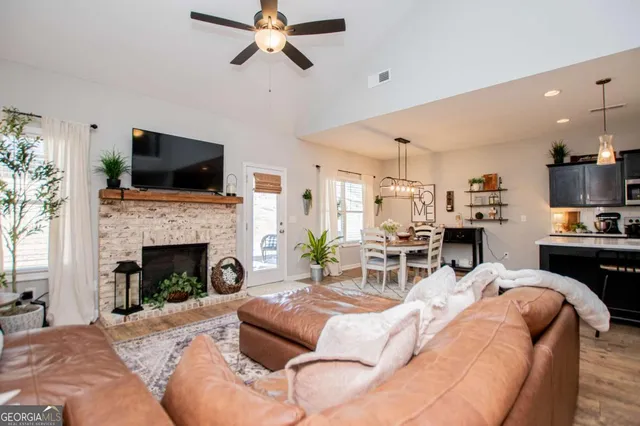 a living room with furniture and a potted plant