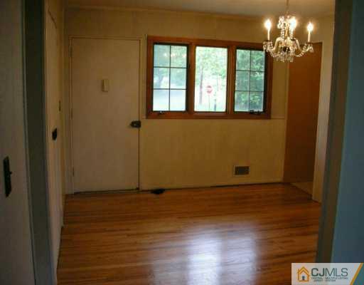 210 Princeton Road Old Bridge, NJ 08859 - Photo 4 of 8 a view of empty room with wooden floor and fan