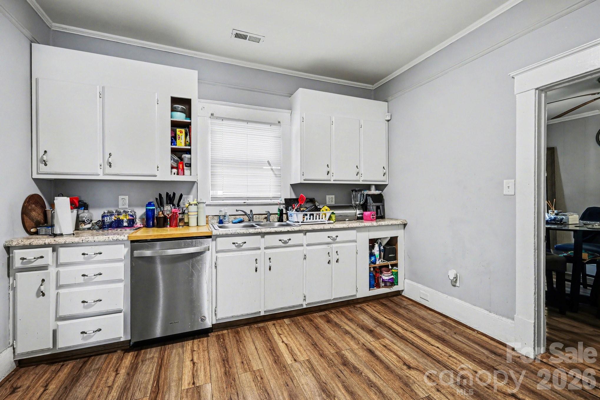 522 Elm Street Salisbury, NC 28144 - Photo 8 of 20 a kitchen with granite countertop white cabinets and white appliances