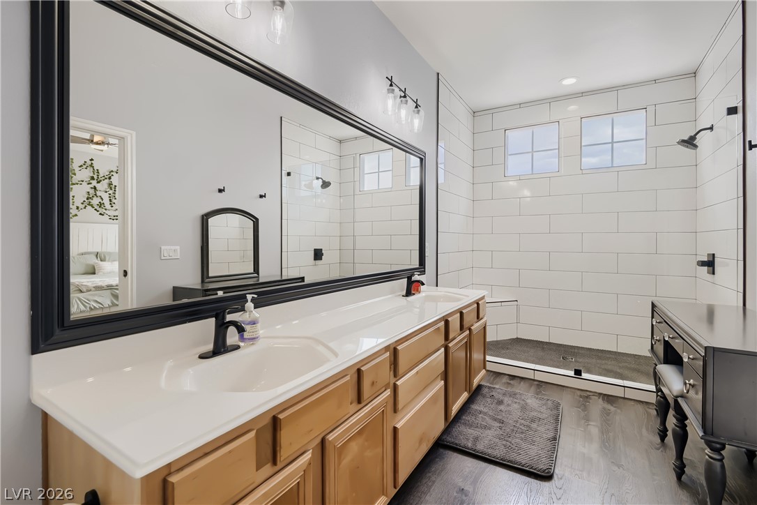 251 Integrity Ridge Drive Henderson, NV 89052 - Photo 18 of 28 Dual vanities and an expansive mirror elevate this bright, functional primary bathroom.