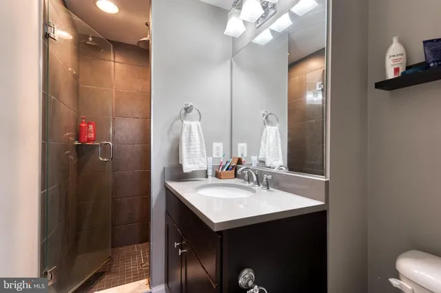 a bathroom with a sink vanity and a mirror