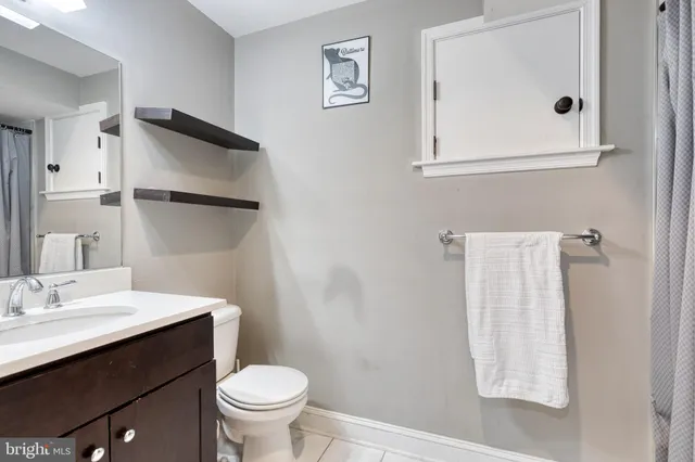 a bathroom with a sink toilet and mirror