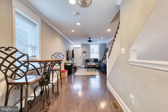 an entryway and dining room with furniture