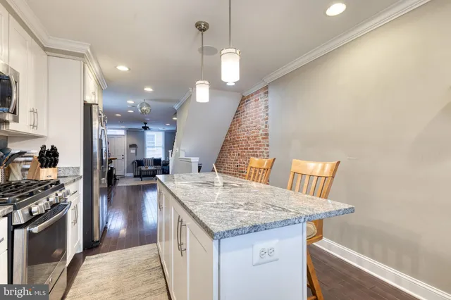 a kitchen with a stove a sink and a refrigerator