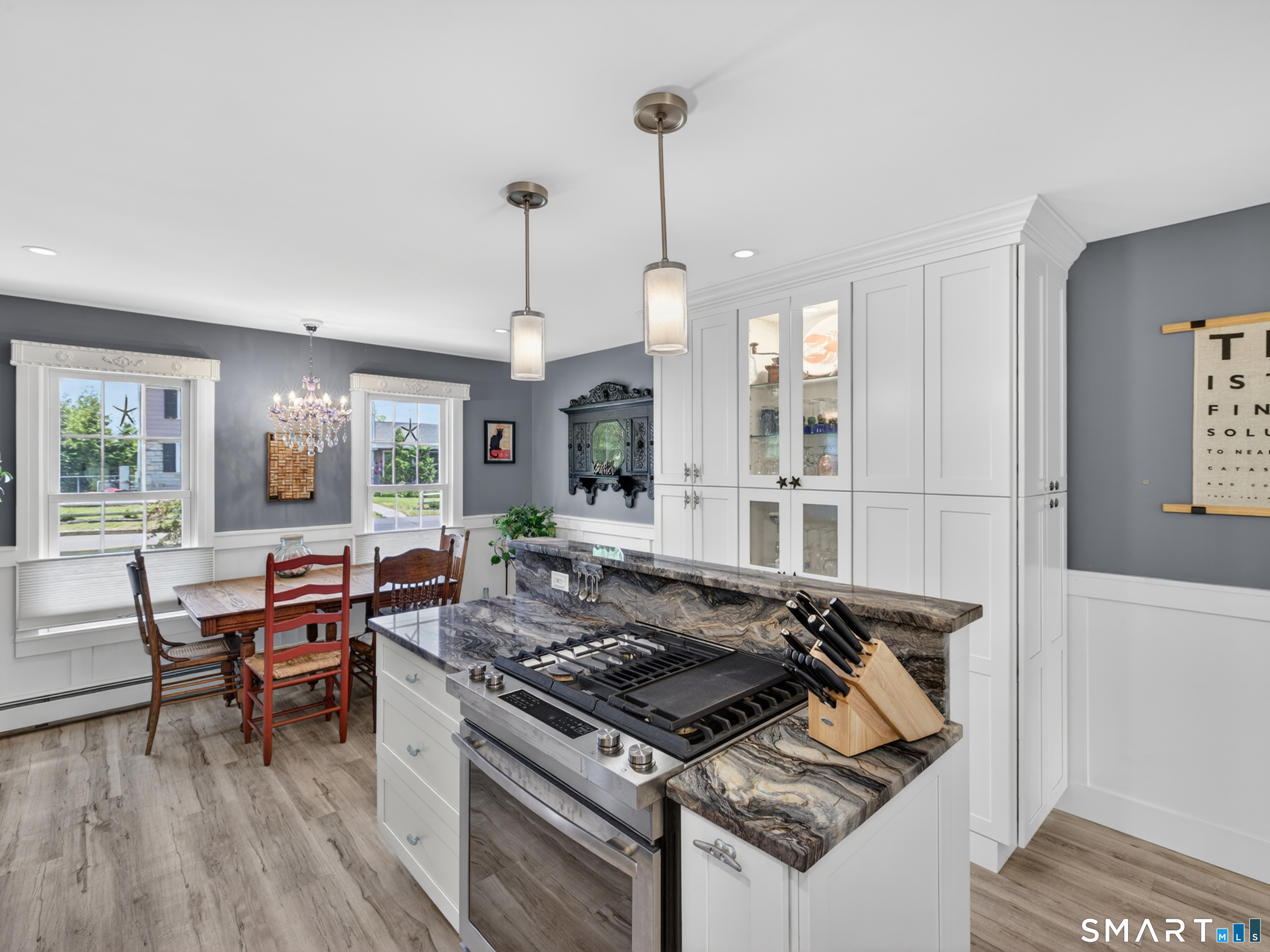 82 Pratt Road Clinton, CT 06413 - Photo 10 of 40 Placement of the gas stove in the island helps to create a functional and stunning kitchen. In addition, the lit built-in offers significant storage options as well as display space.