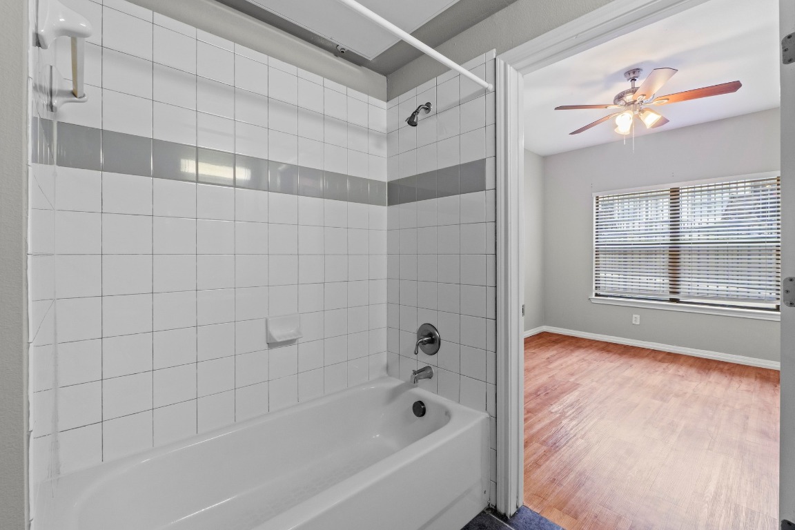 2502 Leon Street, Unit 213 Austin, TX 78705 - Photo 14 of 20 Bathroom featuring shower combination, wood finished floors, and a ceiling fan