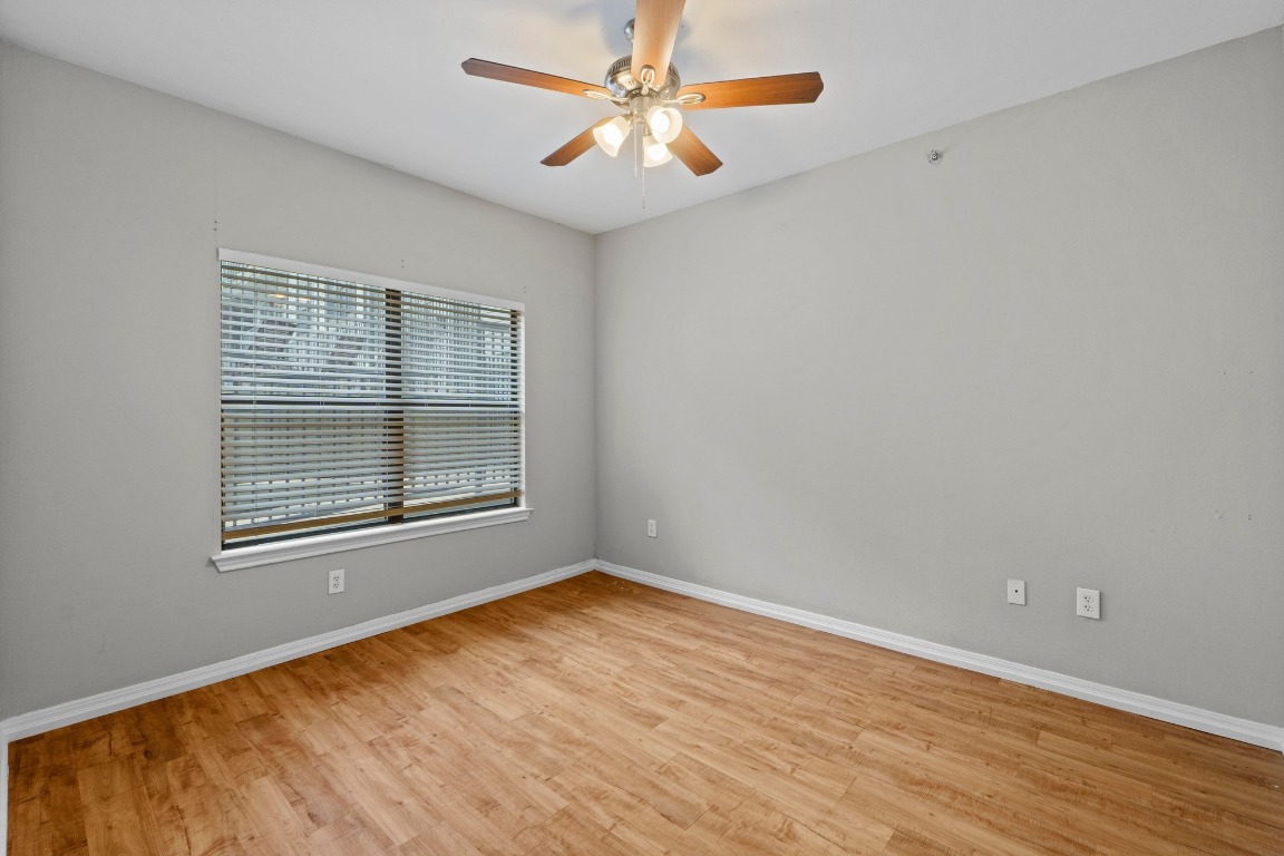 2502 Leon Street, Unit 213 Austin, TX 78705 - Photo 9 of 20 Spare room featuring light wood-style flooring and ceiling fan