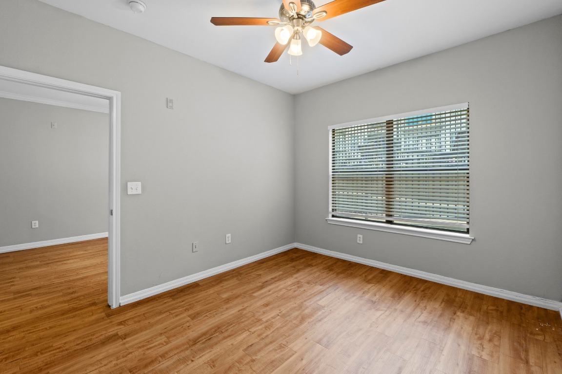 2502 Leon Street, Unit 213 Austin, TX 78705 - Photo 10 of 20 Unfurnished room with light wood-style floors and ceiling fan