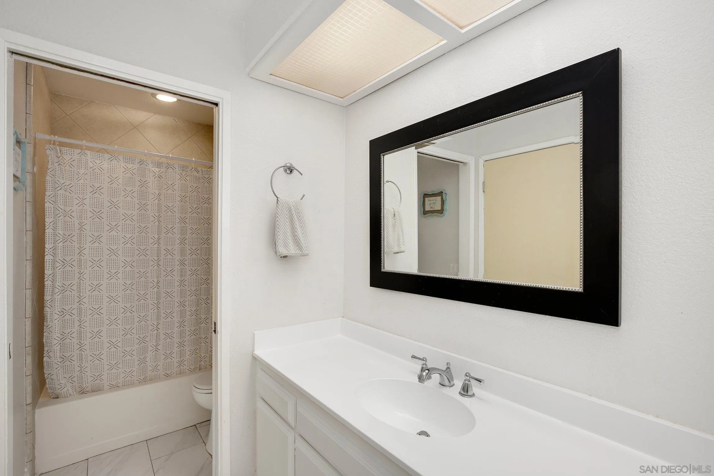 320 Grapevine Road, Unit 15 Vista, CA 92083 - Photo 14 of 18 a bathroom with a bathtub a sink and a mirror