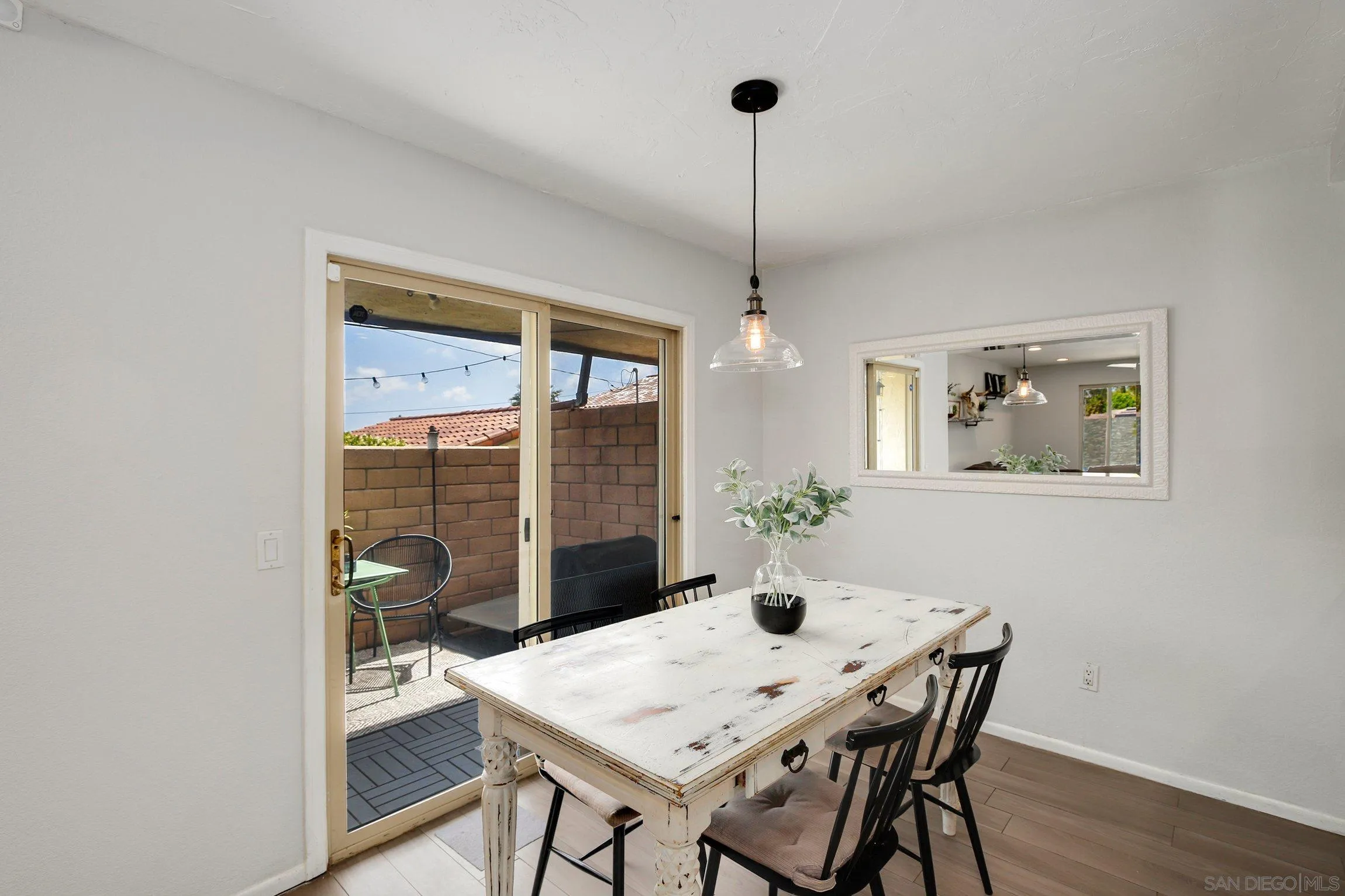 320 Grapevine Road, Unit 15 Vista, CA 92083 - Photo 5 of 18 a view of a dining room with furniture wooden floor and chandelier