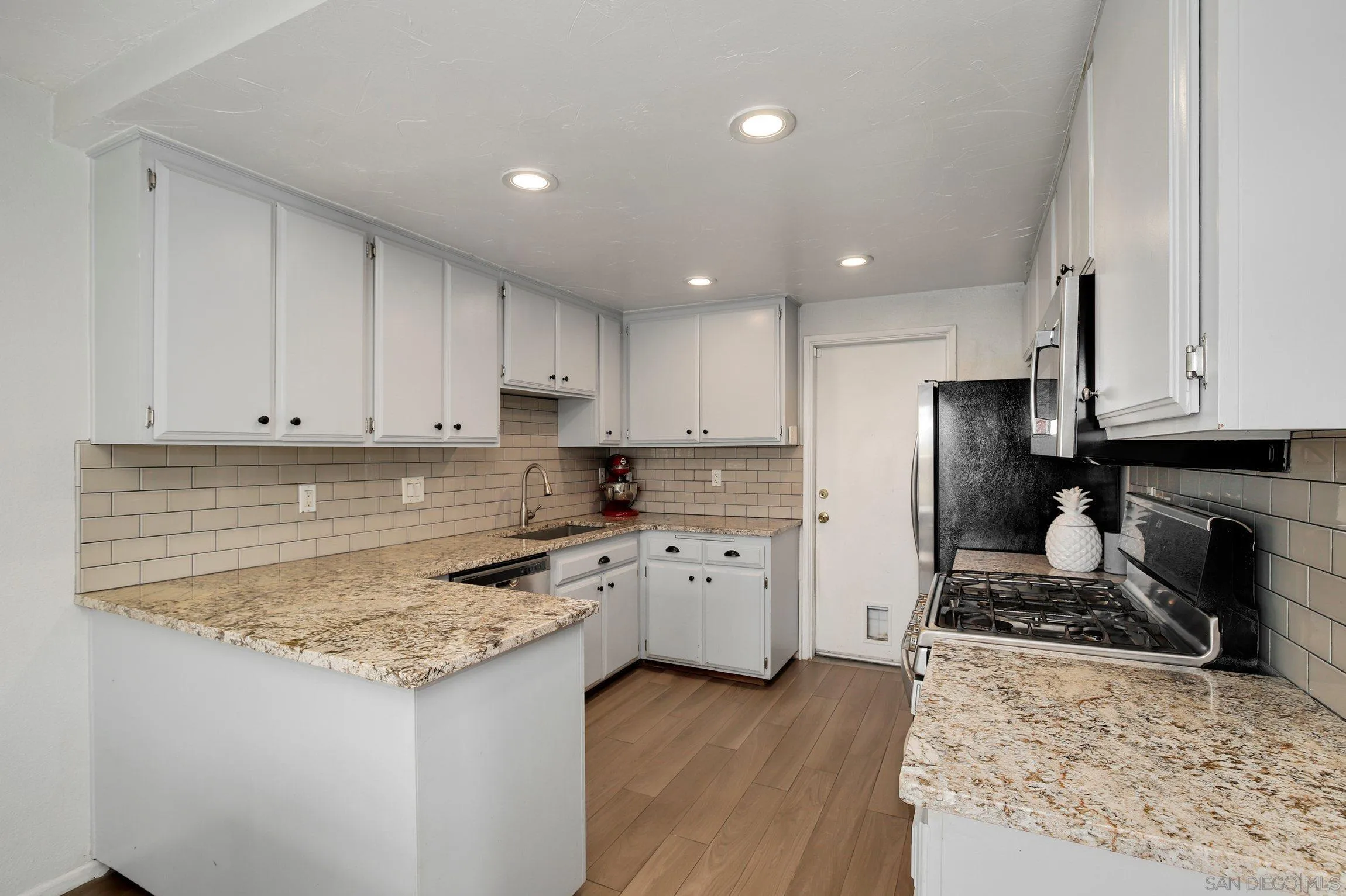 320 Grapevine Road, Unit 15 Vista, CA 92083 - Photo 6 of 18 a kitchen with granite countertop a sink stove and refrigerator
