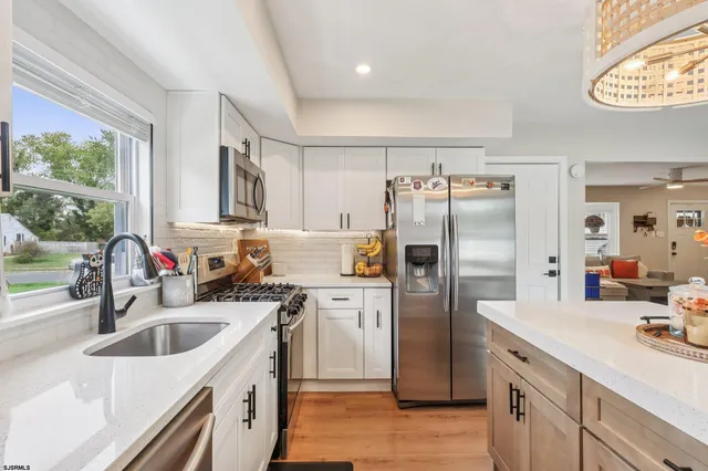 a kitchen with a sink stove and refrigerator