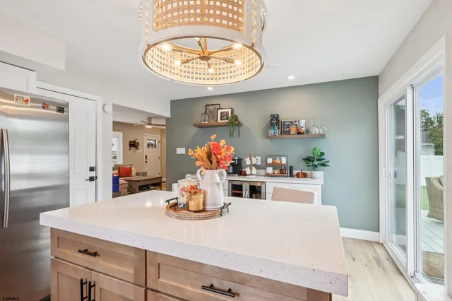 a kitchen with a refrigerator and a wooden floor
