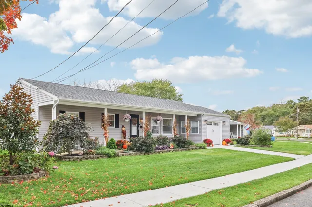 a front view of house with yard and green space
