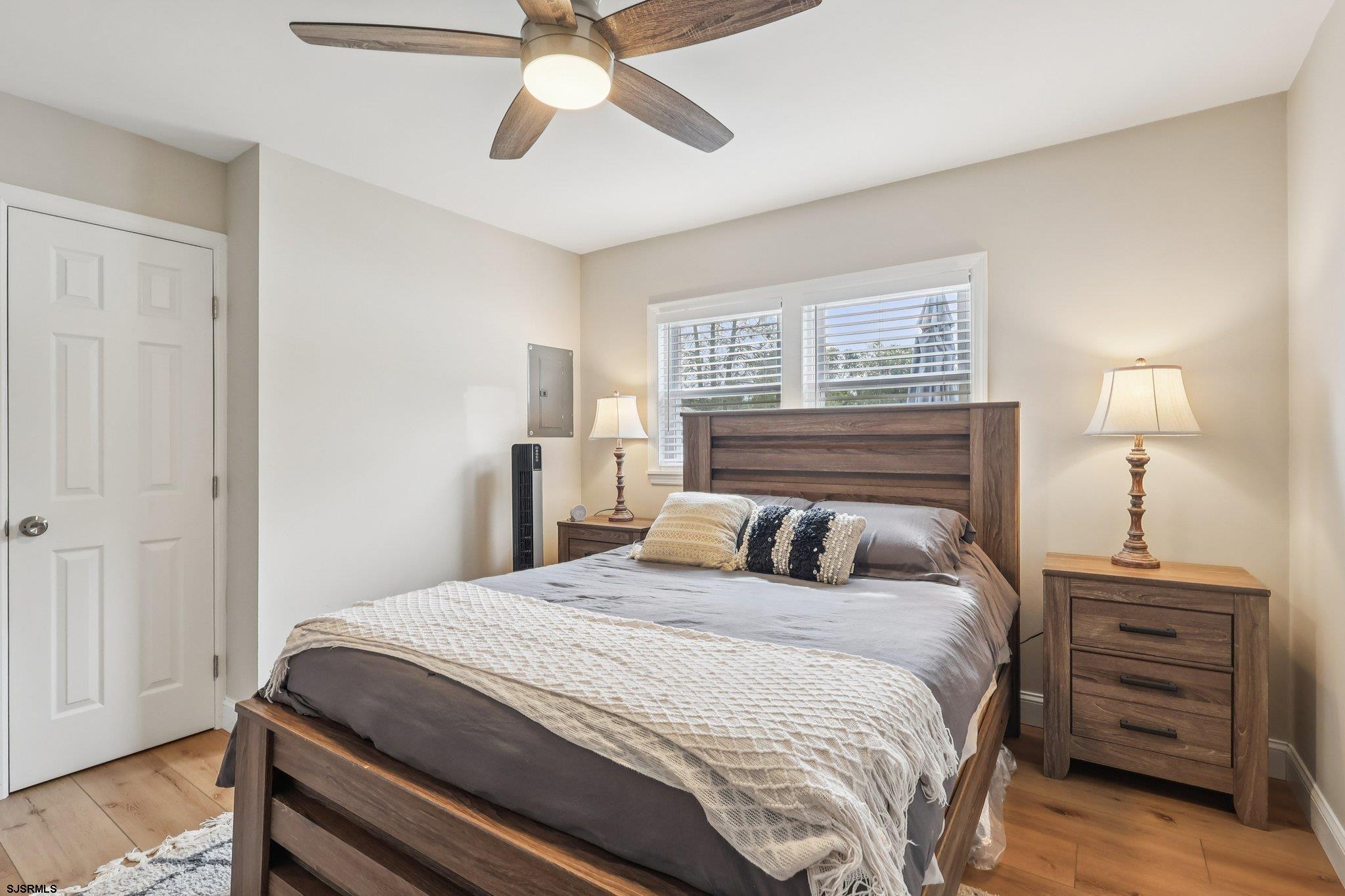 13 Gulph Mill Road Somers Point, NJ 08244 - Photo 21 of 43 a bedroom with a bed and a chandelier