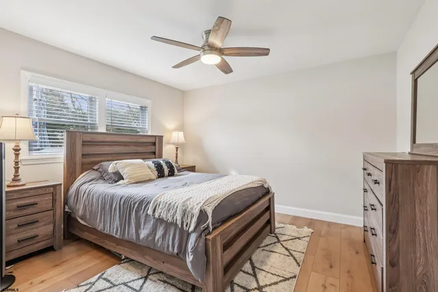 a bedroom with a bed and a ceiling fan