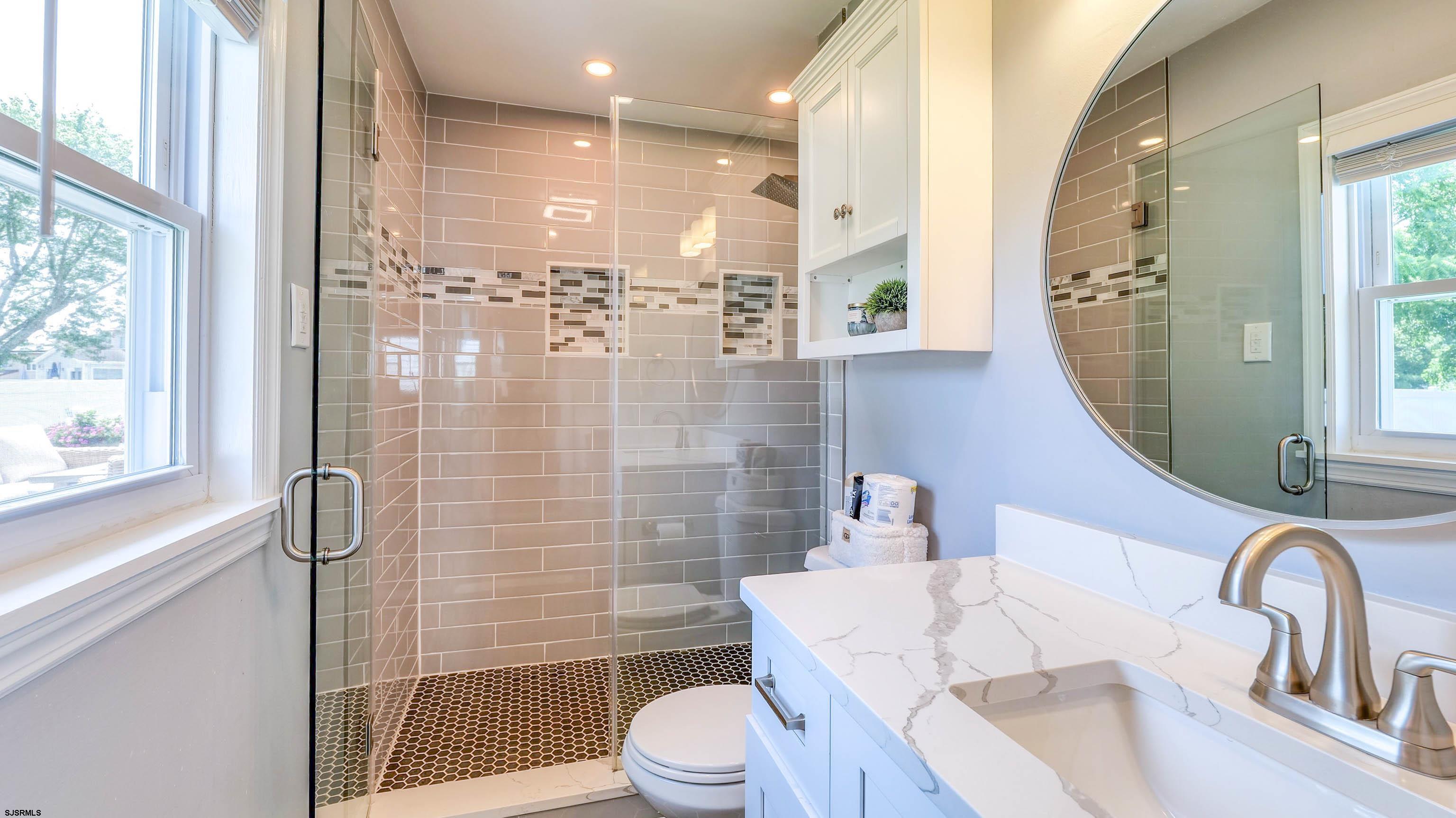 13 Gulph Mill Road Somers Point, NJ 08244 - Photo 26 of 43 a bathroom with a sink a toilet and shower